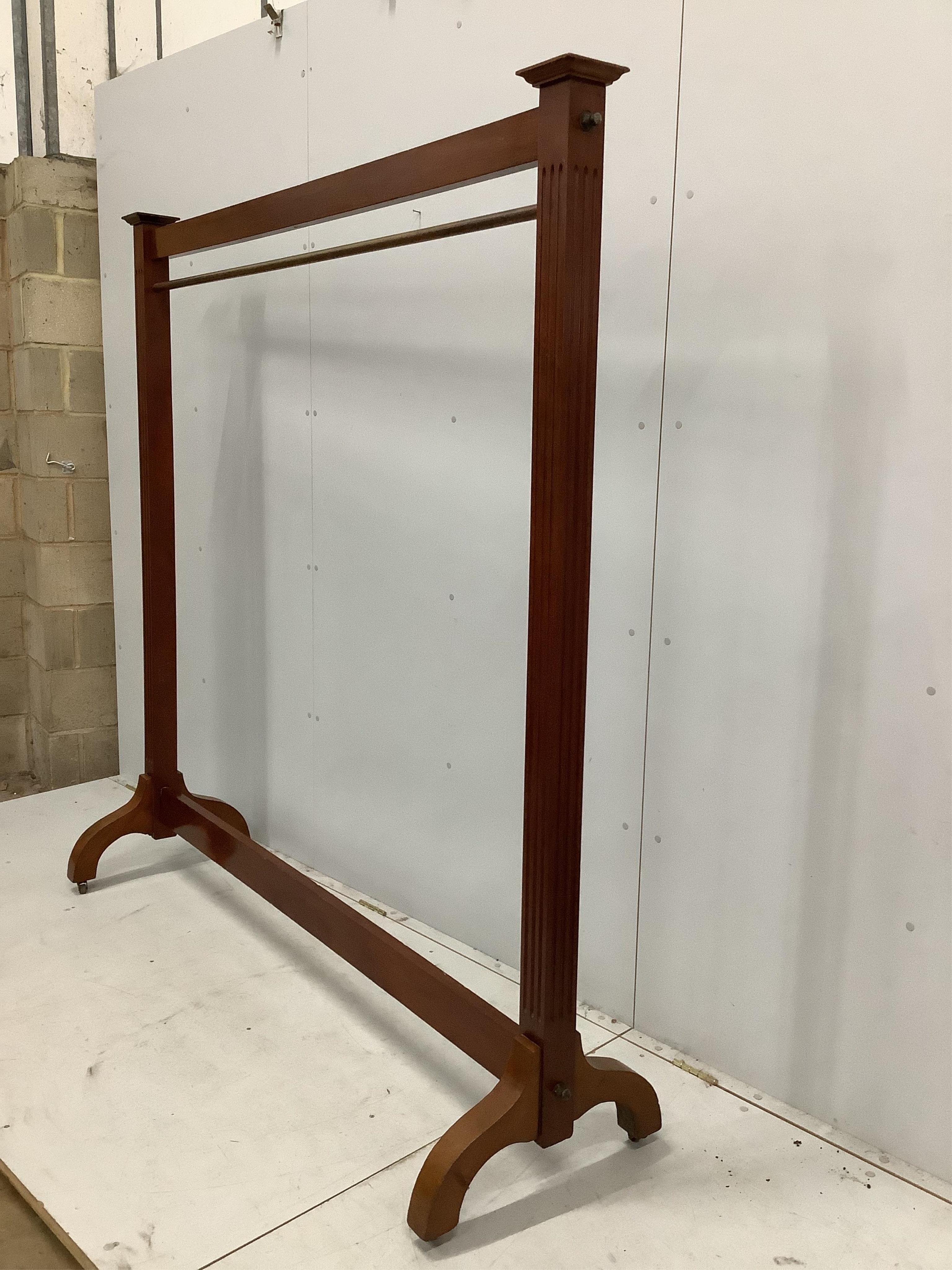 A mahogany dress rack, with reeded uprights, ex Liberty’s, width 182cm, height 184cm. Condition - fair